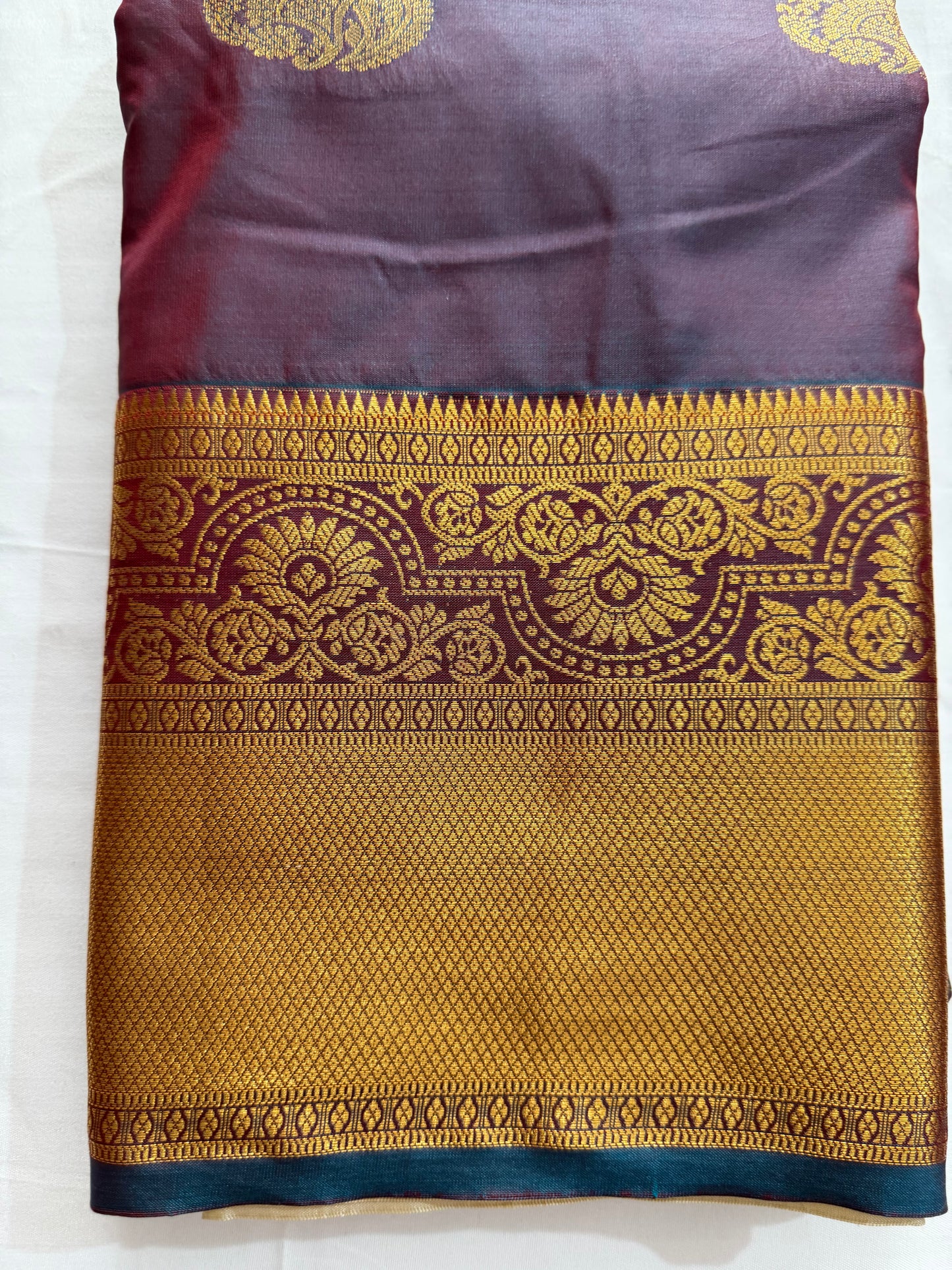 Silk in Kanchipuram boarder Saree with Zari boader -royal purple or violet base, heavily embellished with elaborate gold Zari patterns